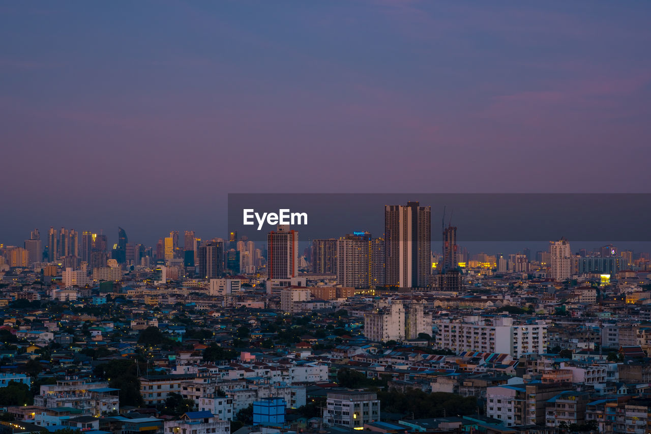 Aerial view of modern buildings in city against sky