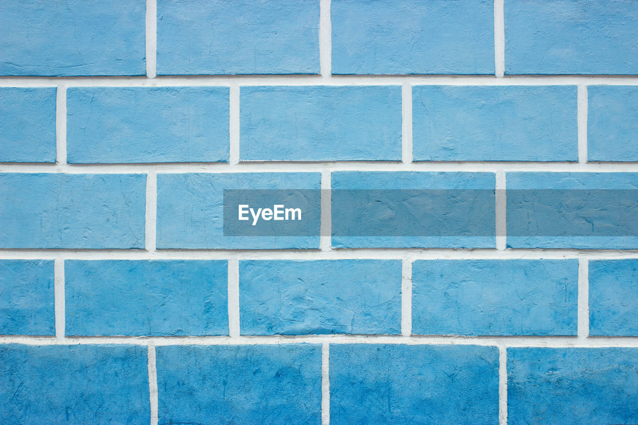 Textures on the blue wall, blue brick wall background.