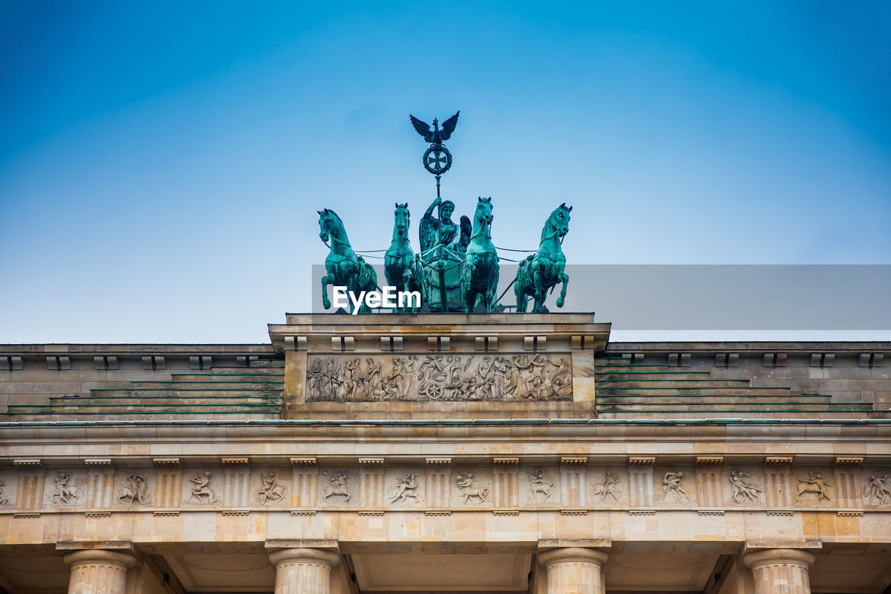 Low angle view of brandenburg gate against blue sky