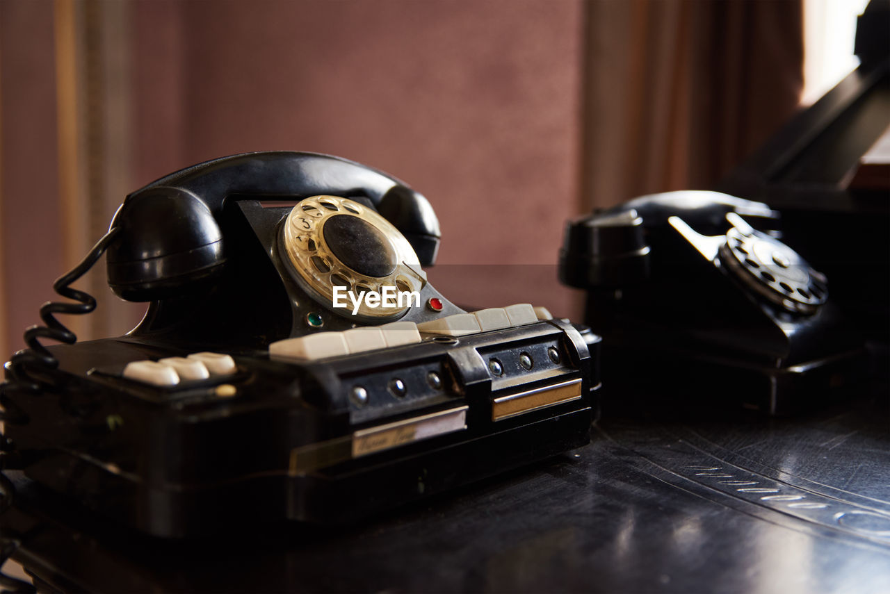 Vintage black phone on the table. retro office