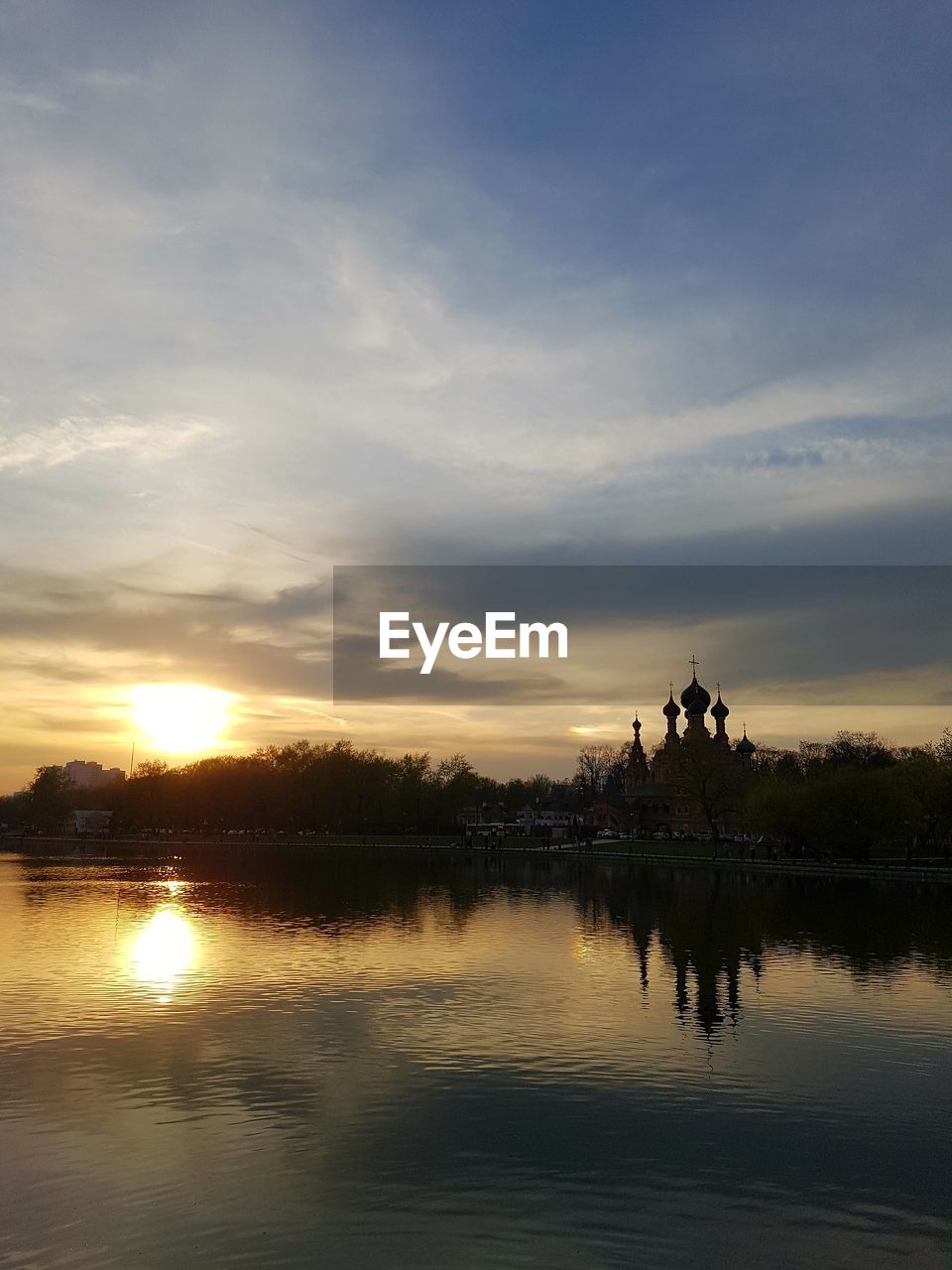 SCENIC VIEW OF LAKE AGAINST ORANGE SKY