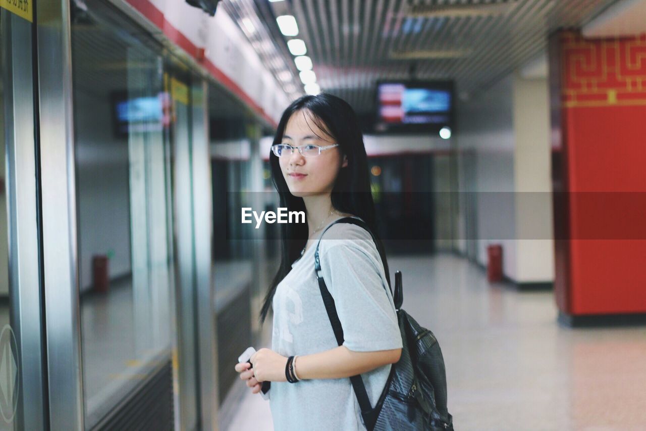 Side view of woman in eyeglasses standing in nanjing university of science and technology