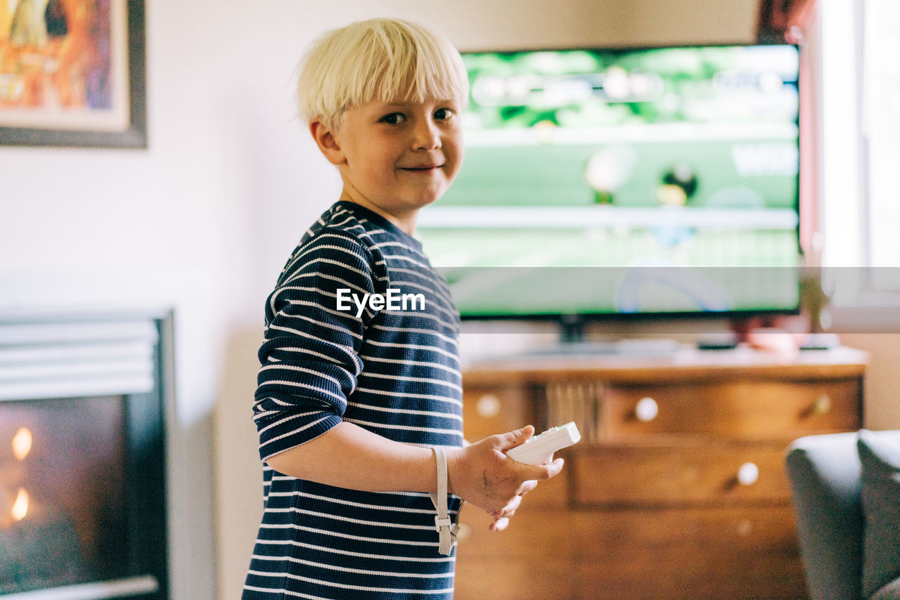 Young boy playing video games on tv