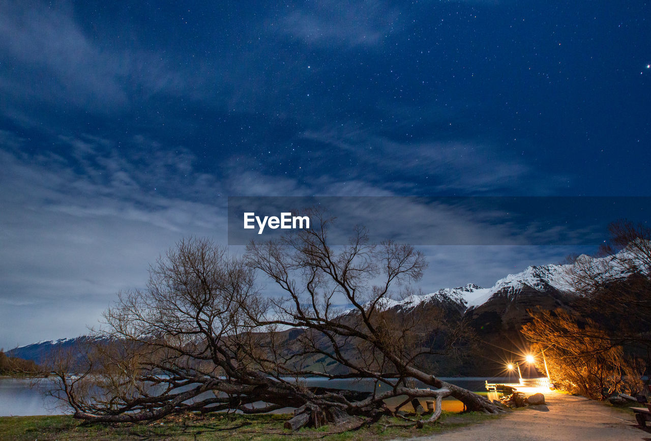 Scenic view of snow covered mountain against sky at night