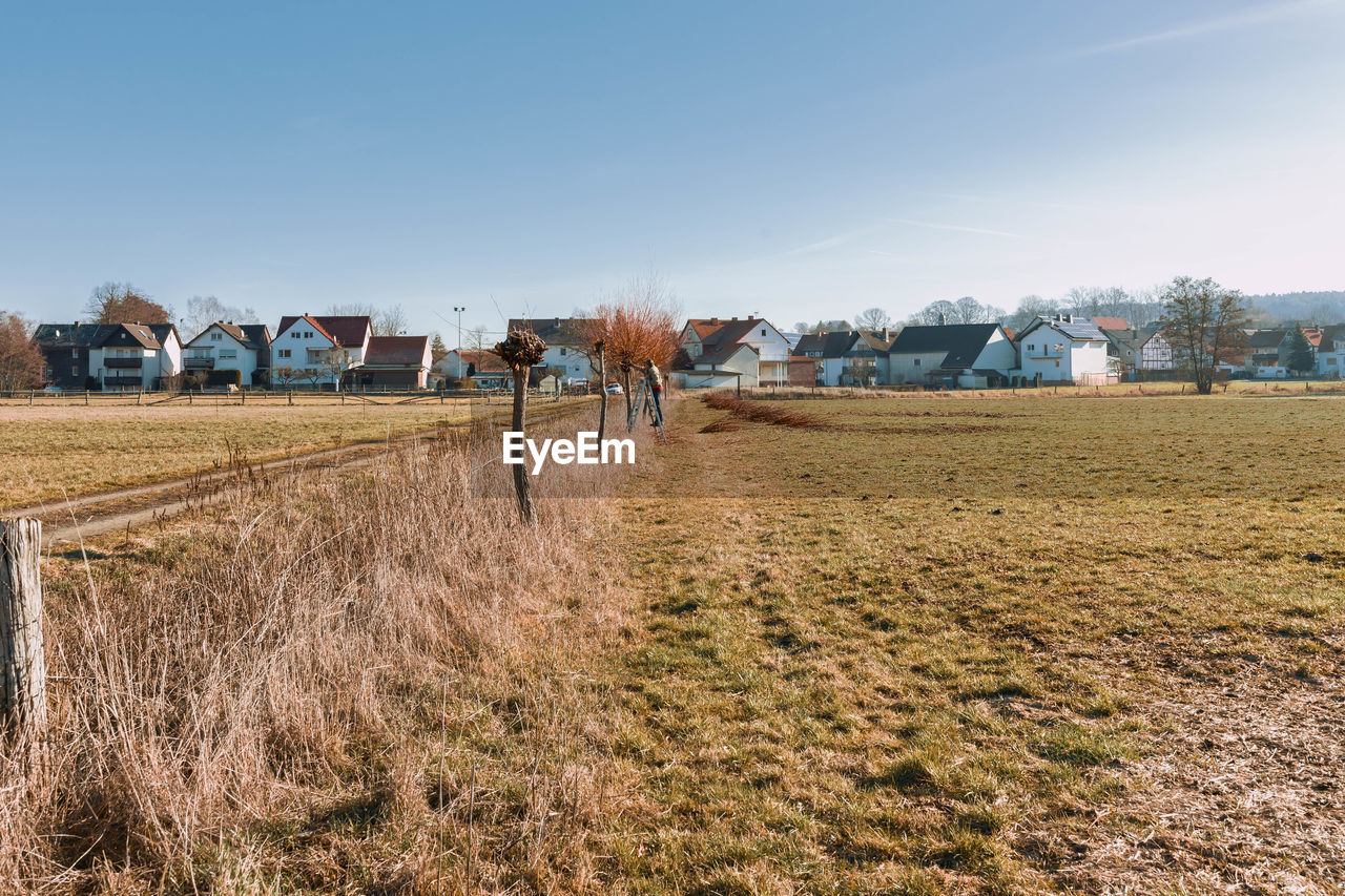 Houses on field against clear sky