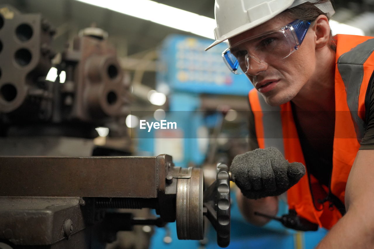 Portrait of male worker standing in the heavy industry manufacturing factory.