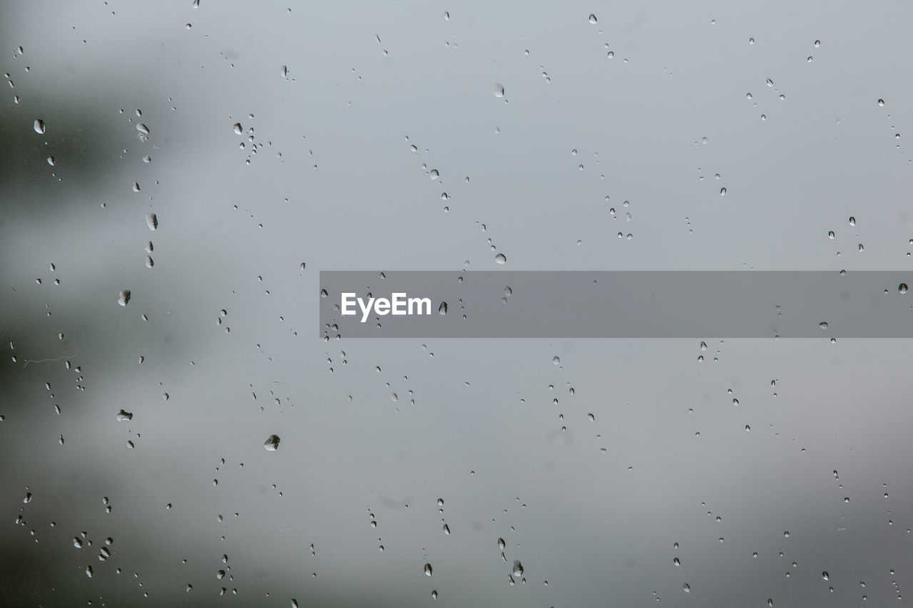 RAINDROPS ON GLASS WINDOW