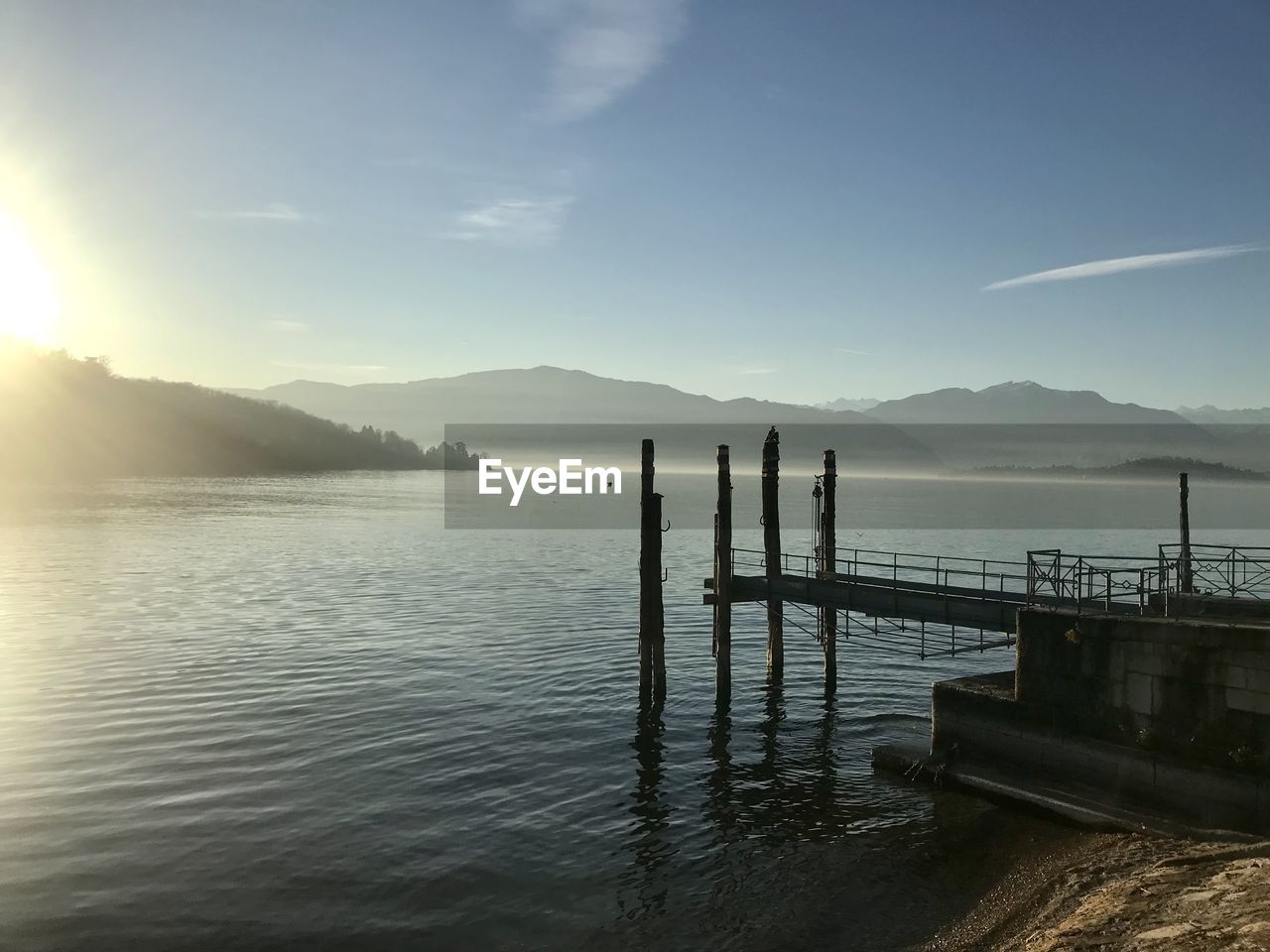 water, sky, sea, nature, scenics - nature, mountain, beauty in nature, horizon, morning, reflection, tranquility, tranquil scene, shore, ocean, pier, dusk, sunlight, cloud, body of water, sunrise, environment, bay, landscape, land, outdoors, coast, sun, mountain range, travel destinations, travel, no people, architecture, beach, idyllic, transportation, day, silhouette, non-urban scene, wood, jetty, fog, trip, vacation, holiday, built structure, blue