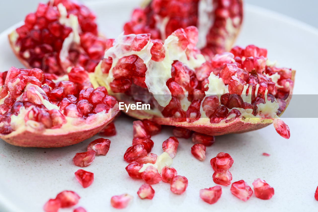 pomegranate, food and drink, food, healthy eating, fruit, plant, pomegranate seed, seed, wellbeing, freshness, red, produce, berry, berries, no people, studio shot, cross section, antioxidant, slice, close-up, indoors, juicy, vitamin, sweet food, cranberry, ripe