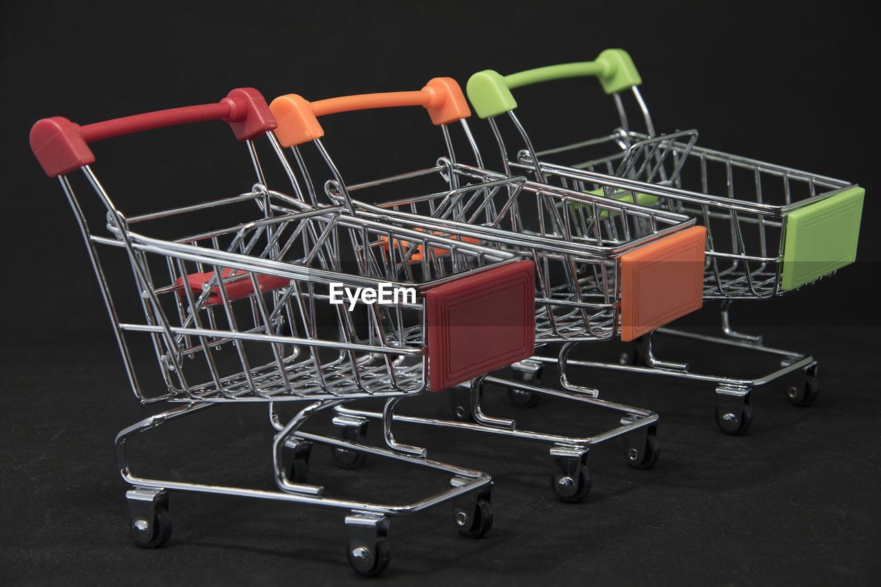 Close-up of miniature shopping carts on table