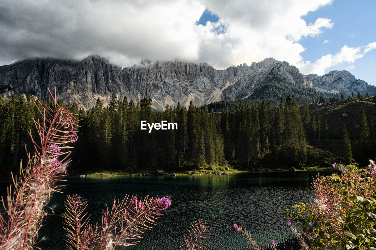 Scenic view of lake by mountains against sky