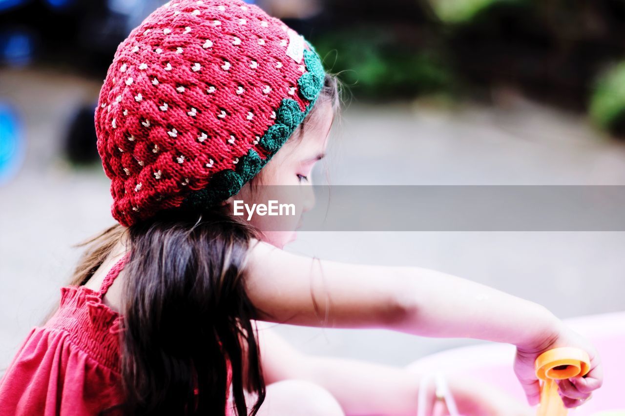 Side view of girl wearing knit hat