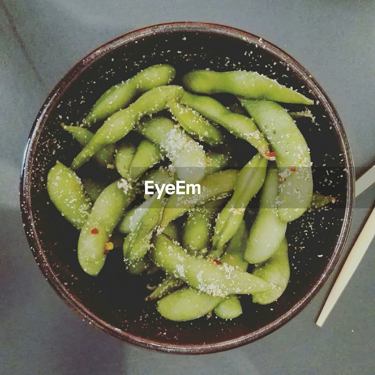 Directly above shot of edamame beans in bowl on table