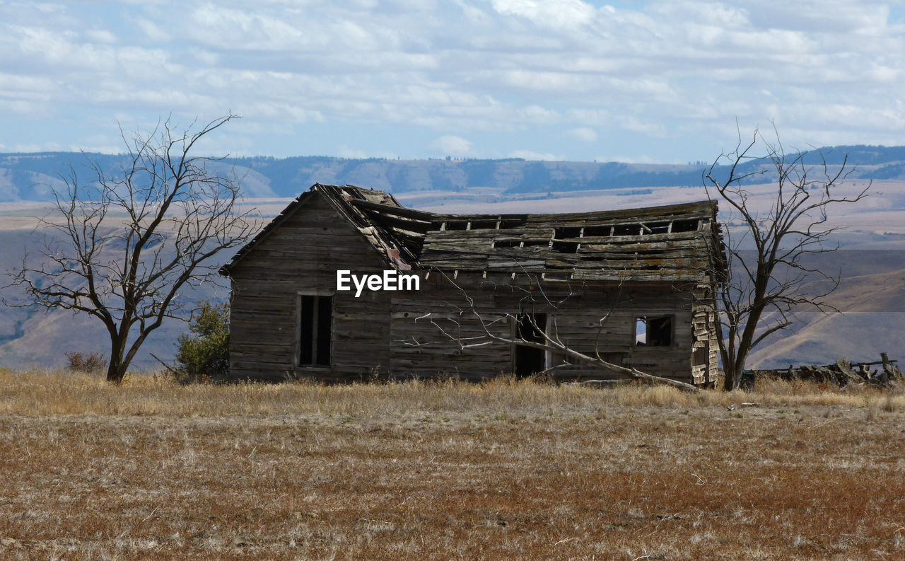 Broken house on field