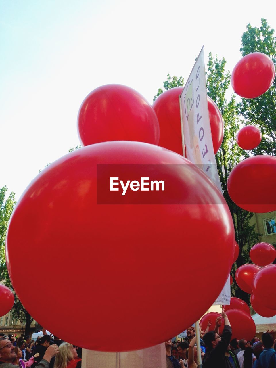 CLOSE-UP OF RED BALLOONS ON WHITE BACKGROUND
