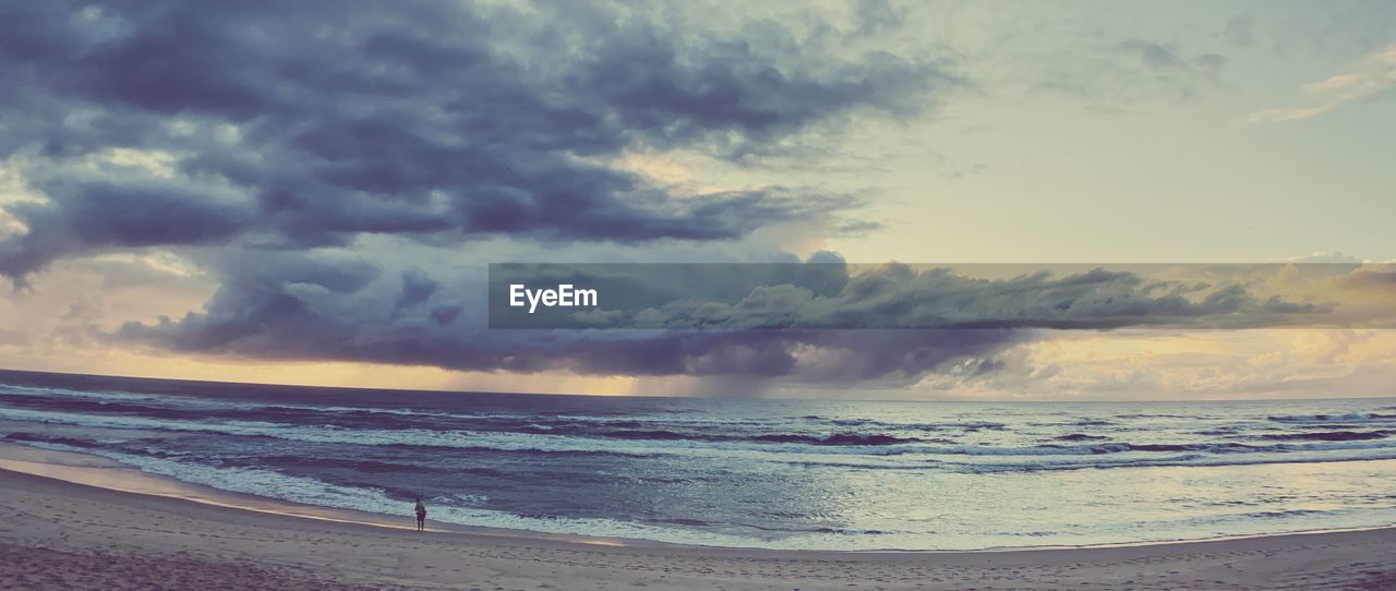 SCENIC VIEW OF BEACH DURING SUNSET