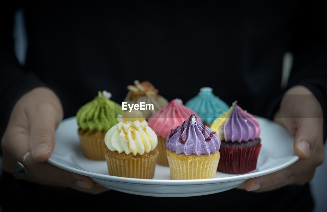 MIDSECTION OF PERSON HOLDING CAKE