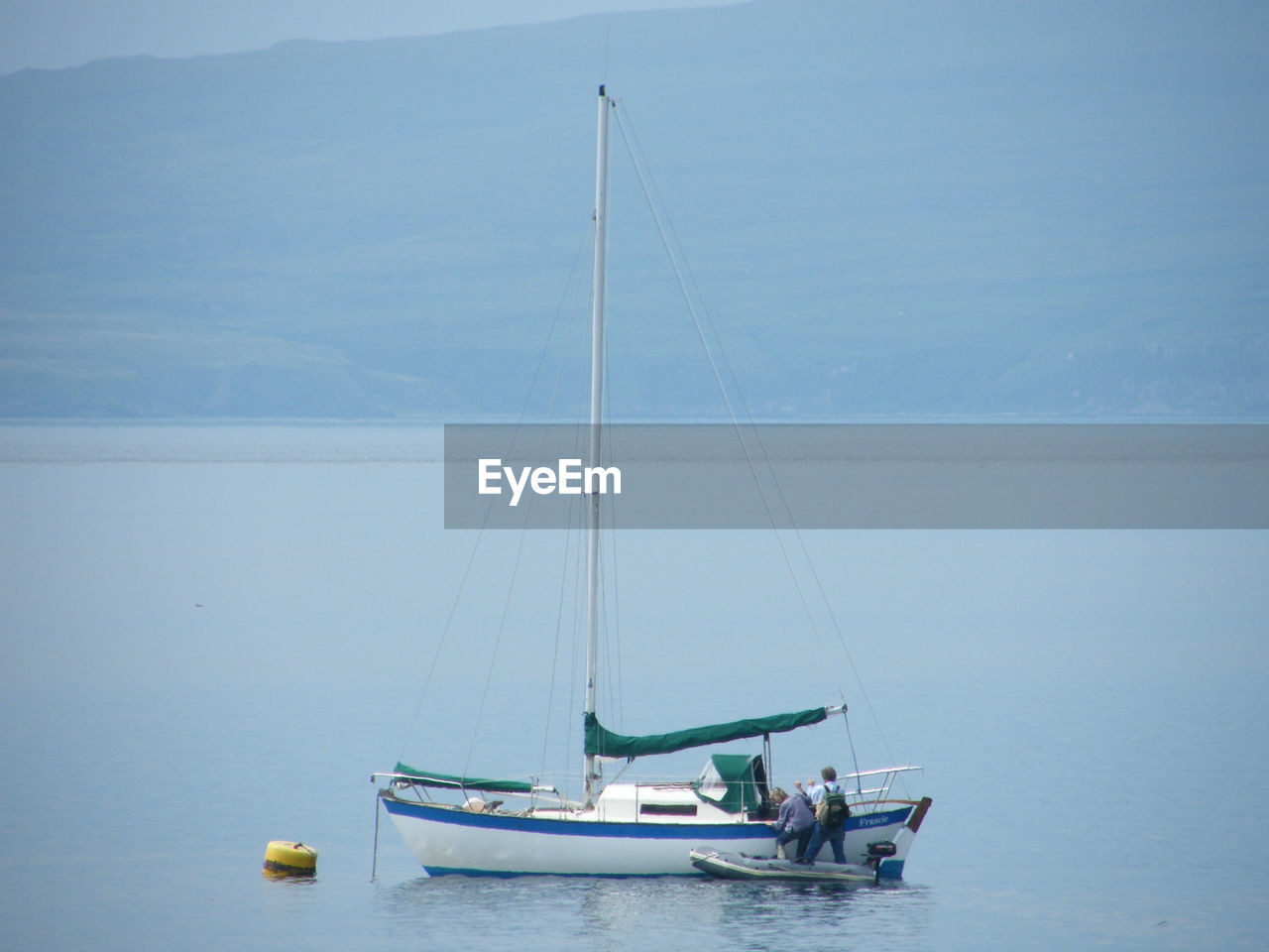 Sailboat in sea against sky