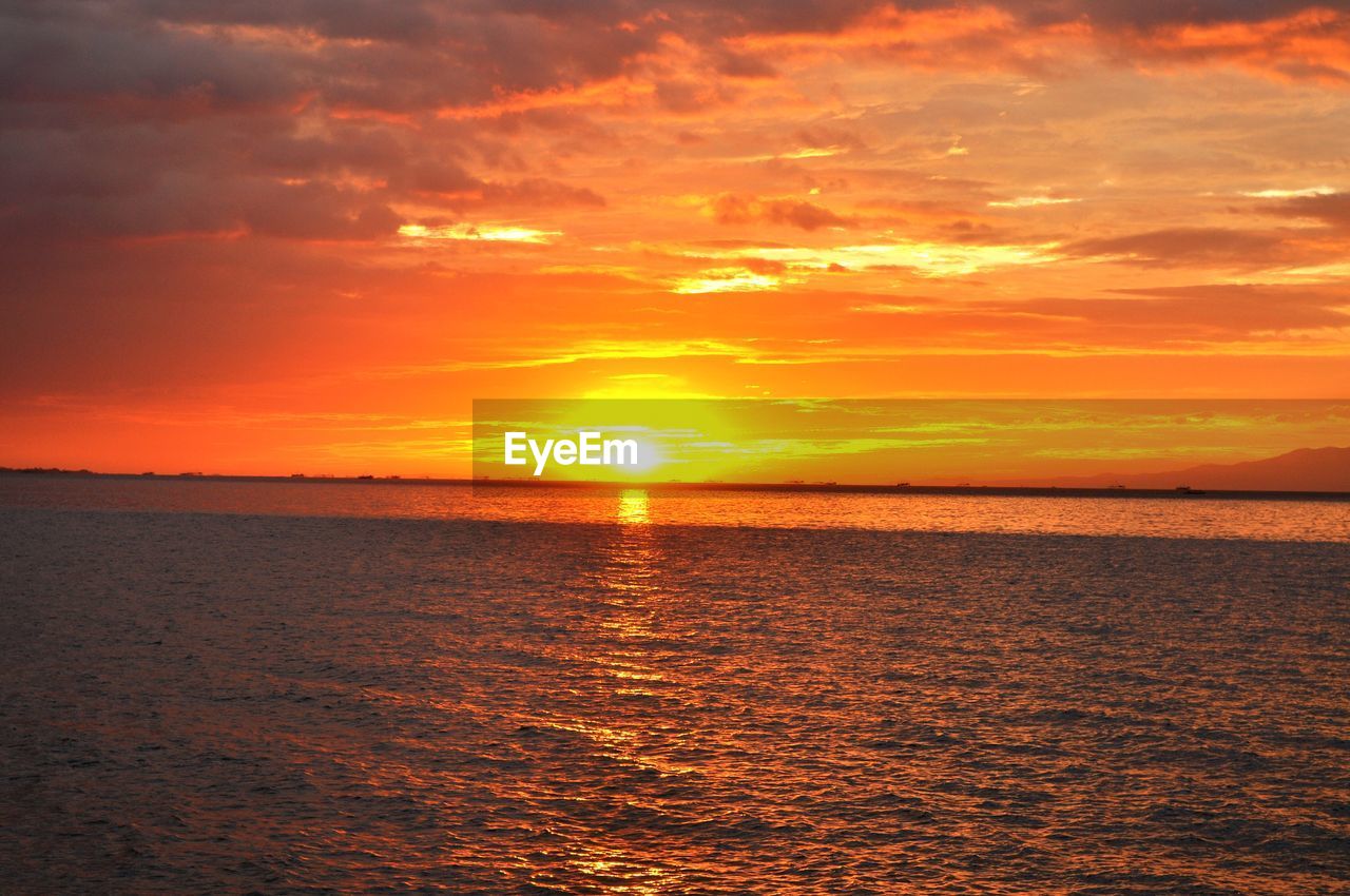 Idyllic shot of manila bay against orange sunset sky