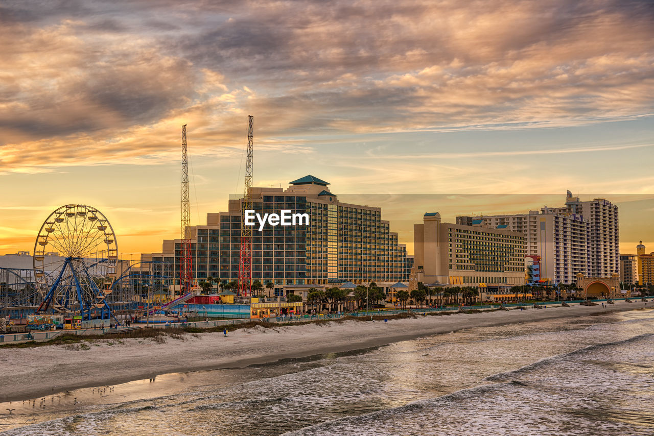 VIEW OF BUILDINGS AGAINST CLOUDY SKY