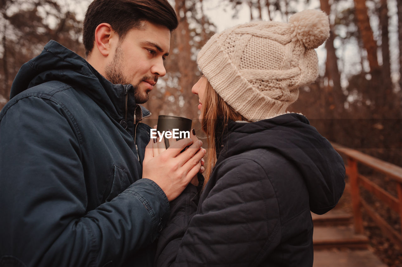 Romantic couple holding cup during winter