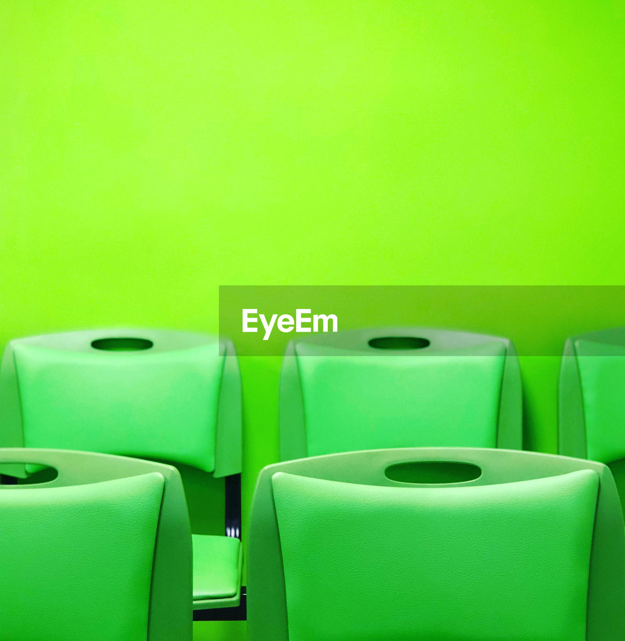 Close up of green chairs and green background 