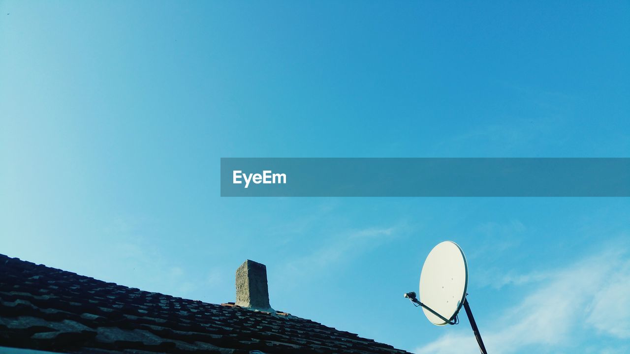 Low angle view of telephone pole against clear sky