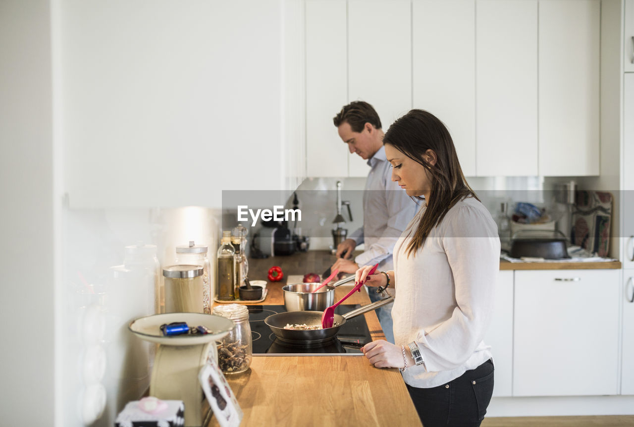 Couple preparing food together in kitchen