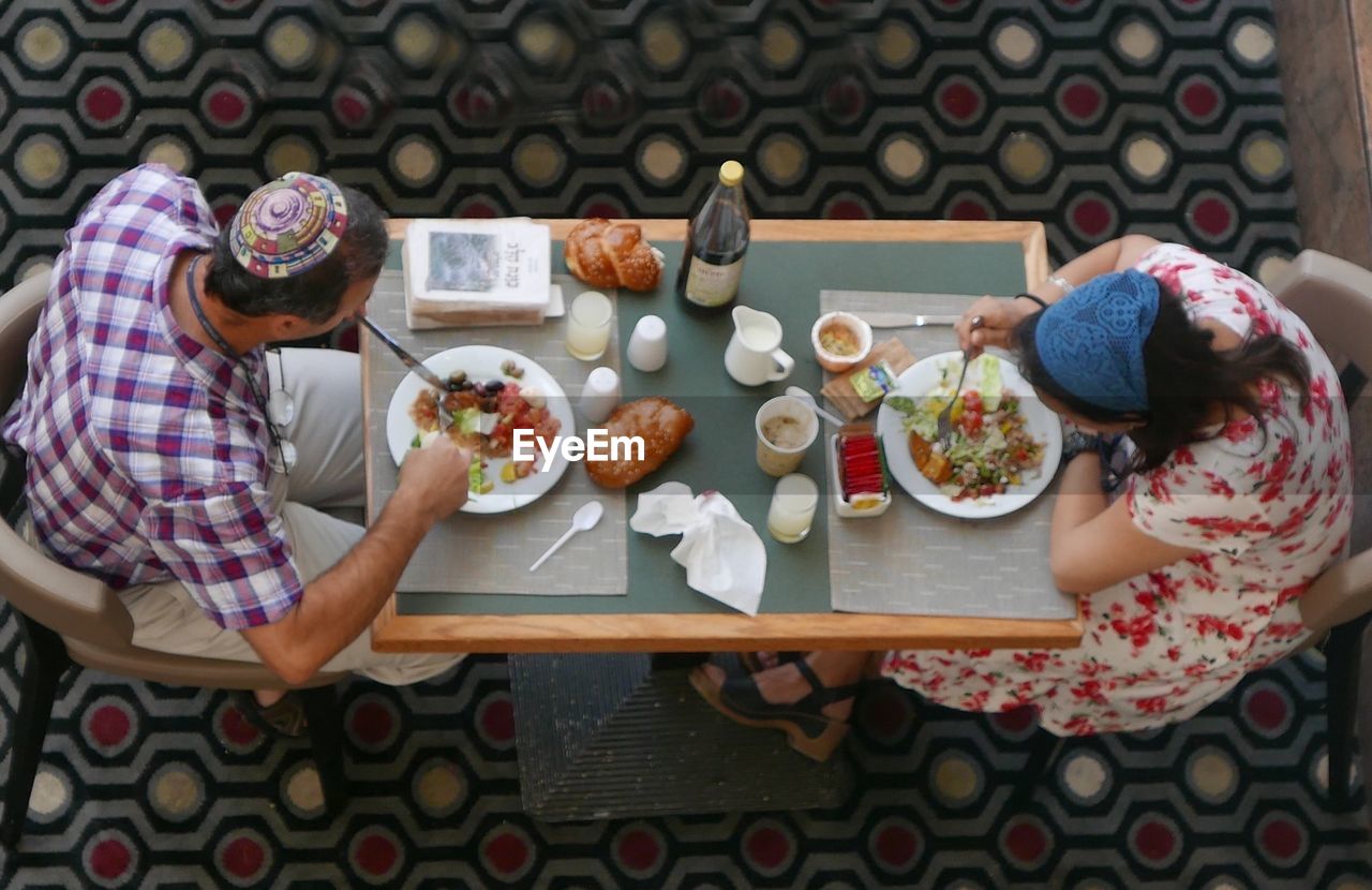 High angle view of couple having food at table
