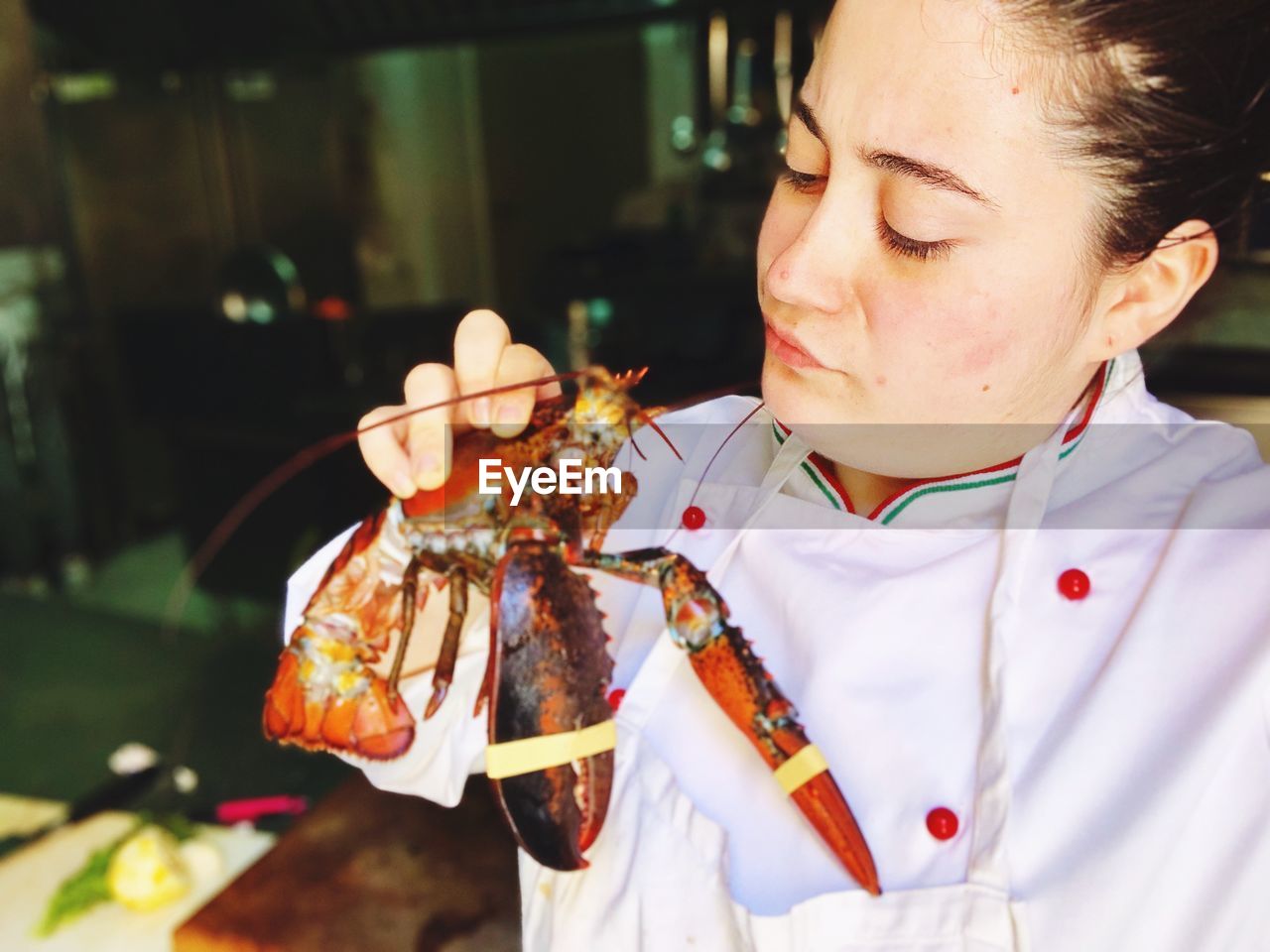 Chef looking at seafood in commercial kitchen