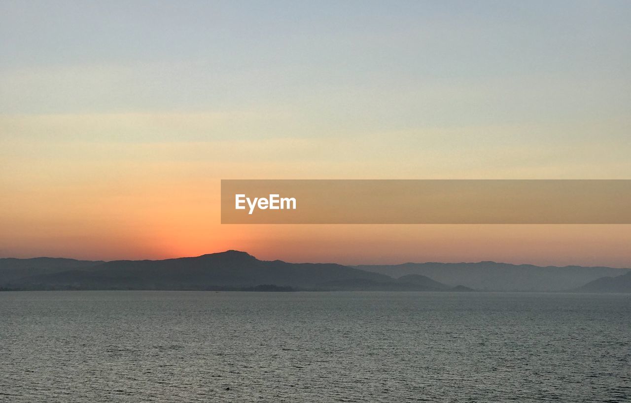 Scenic view of sea against sky during sunset