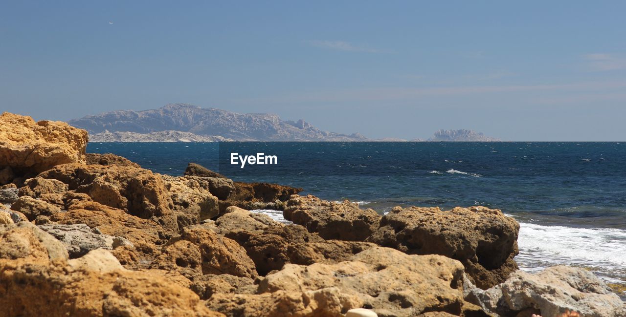 Scenic view of sea against clear blue sky