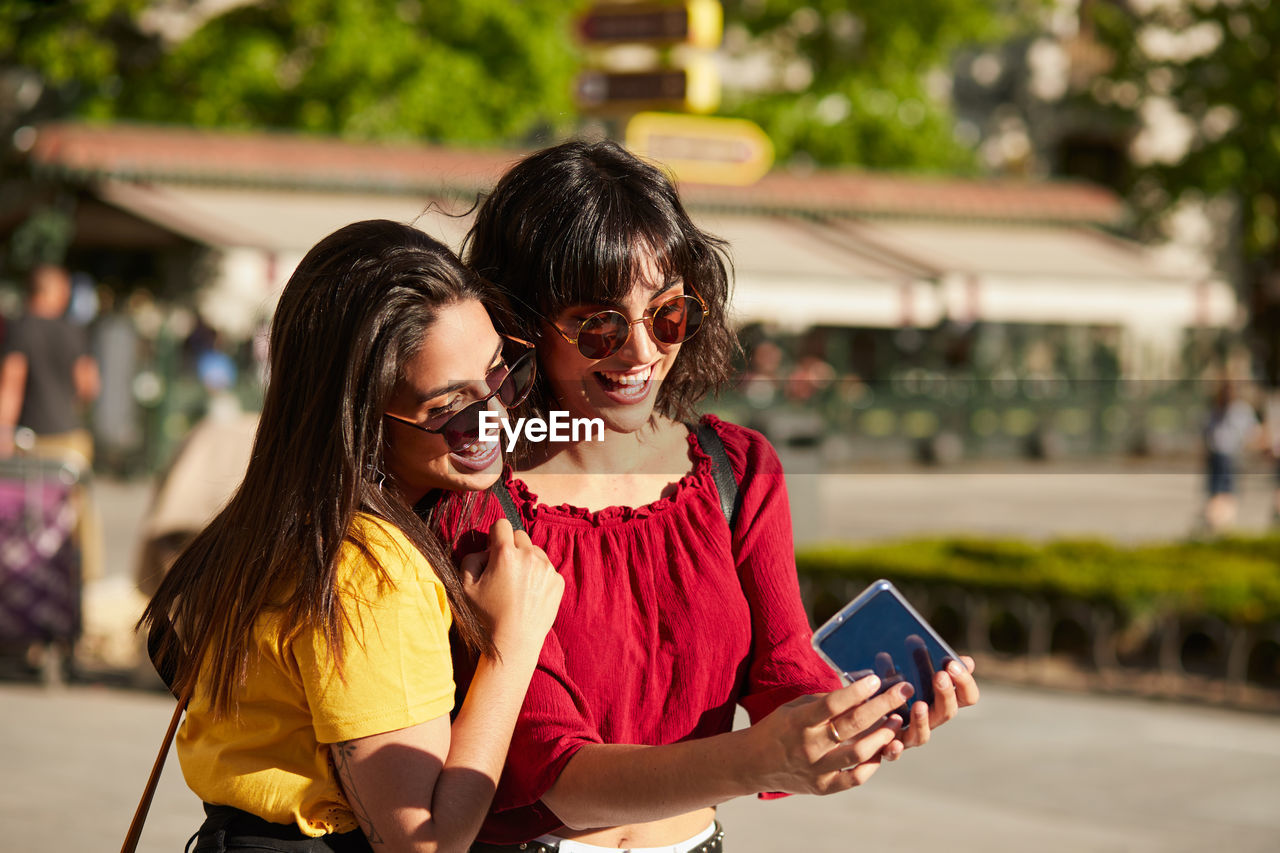 Young woman using mobile phone outdoors