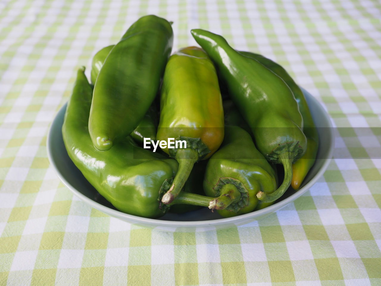 food, food and drink, healthy eating, vegetable, green, produce, tablecloth, freshness, wellbeing, checked pattern, plant, no people, indoors, pepper, high angle view, close-up, pattern, dish, group of objects, organic, still life, bell peppers and chili peppers, fruit, studio shot