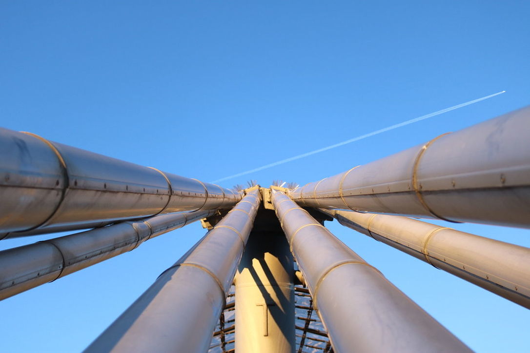 LOW ANGLE VIEW OF INDUSTRIAL BUILDING AGAINST BLUE SKY