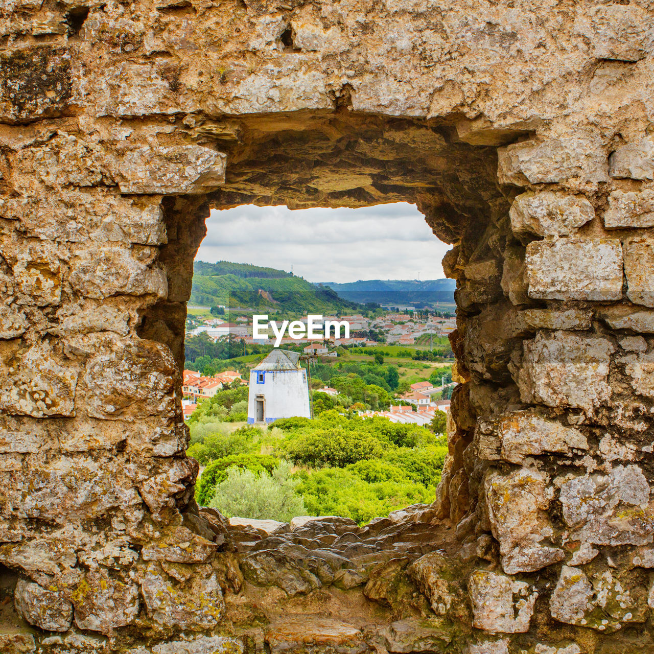 VIEW OF HISTORIC BUILDING SEEN THROUGH WINDOW