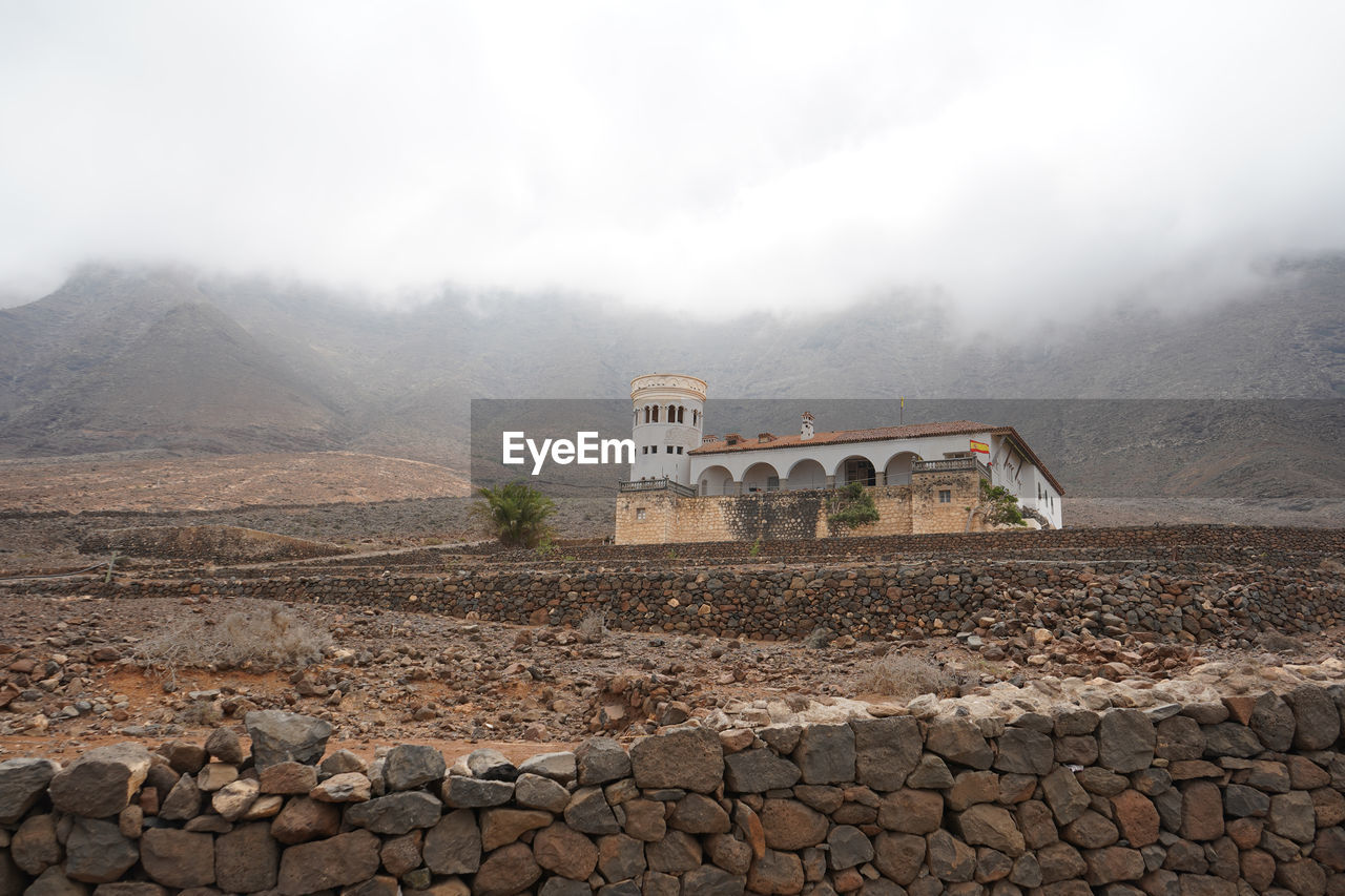 View of stone wall with mountain in background