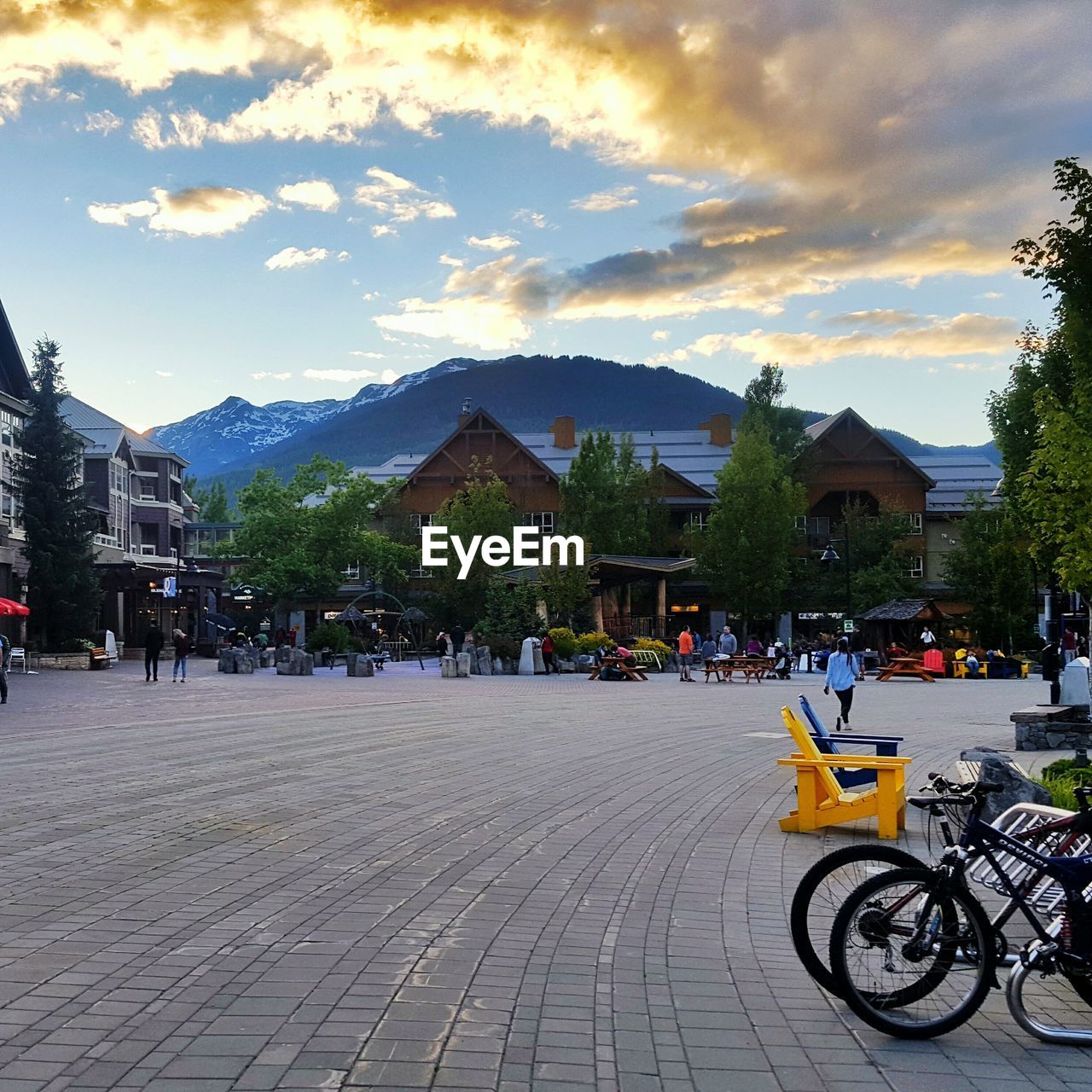 BICYCLES PARKED IN FRONT OF MOUNTAIN AGAINST CLOUDY SKY