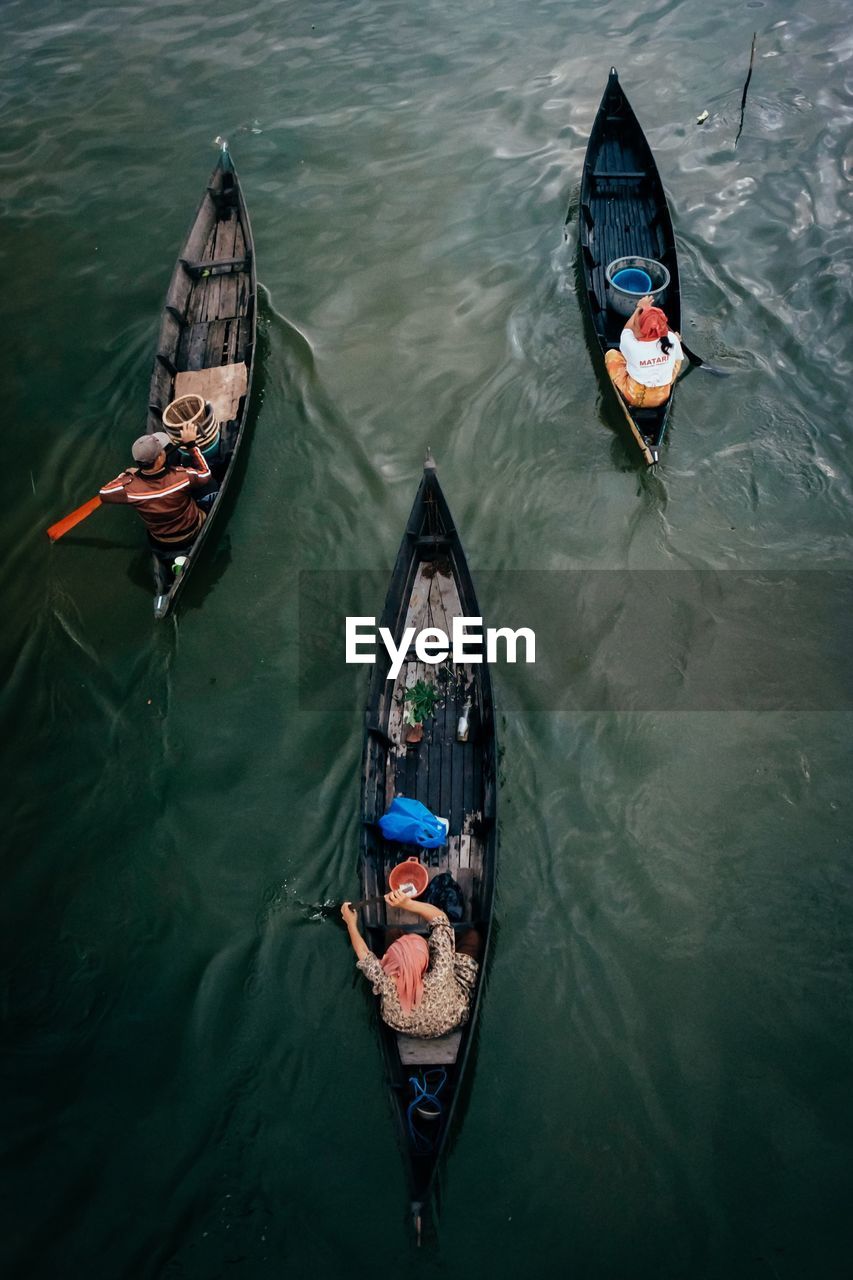 High angle view of men rowing boats in river