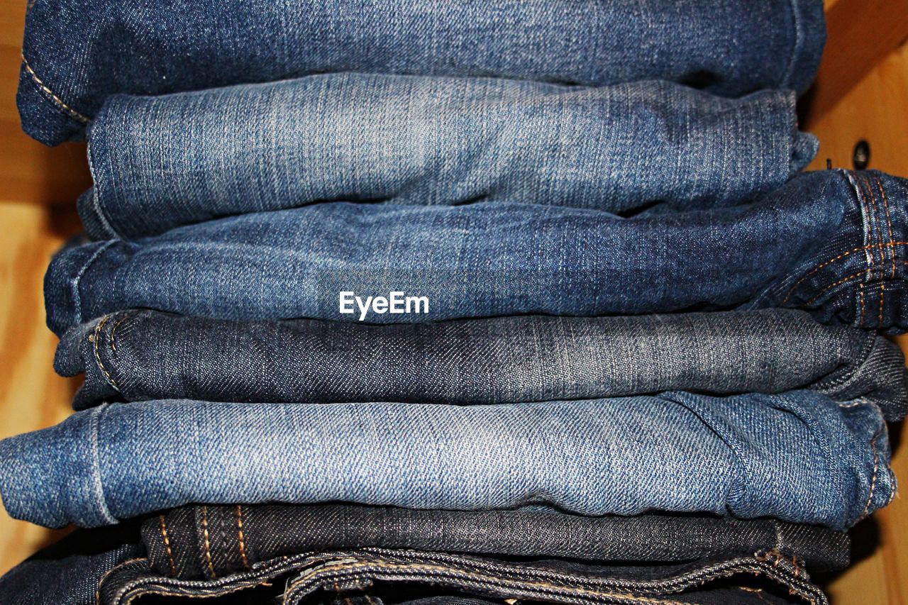 Stack of jeans on shelf