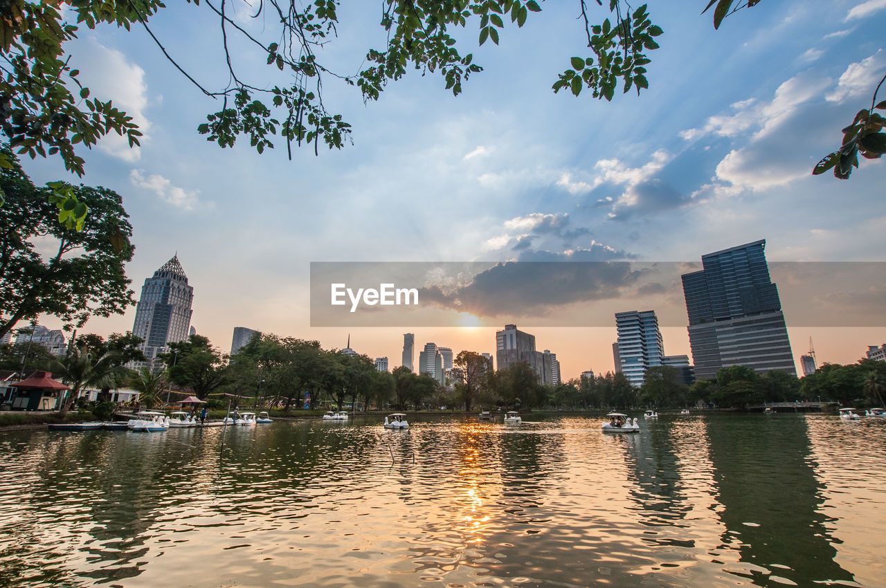 Scenic view of river and buildings against sky