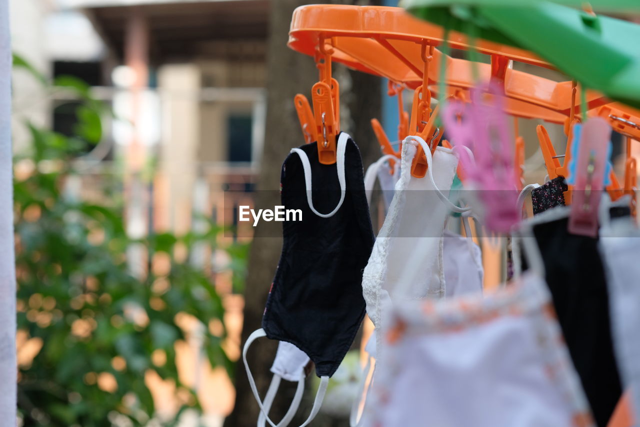 CLOSE-UP OF CLOTHESPINS HANGING ON CLOTHESLINE AT STORE