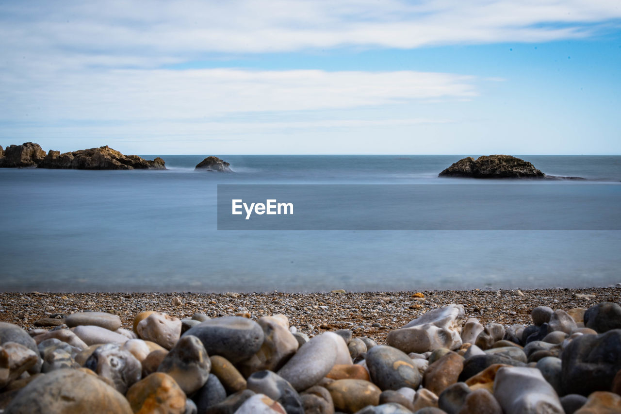 Rocks on beach against sky