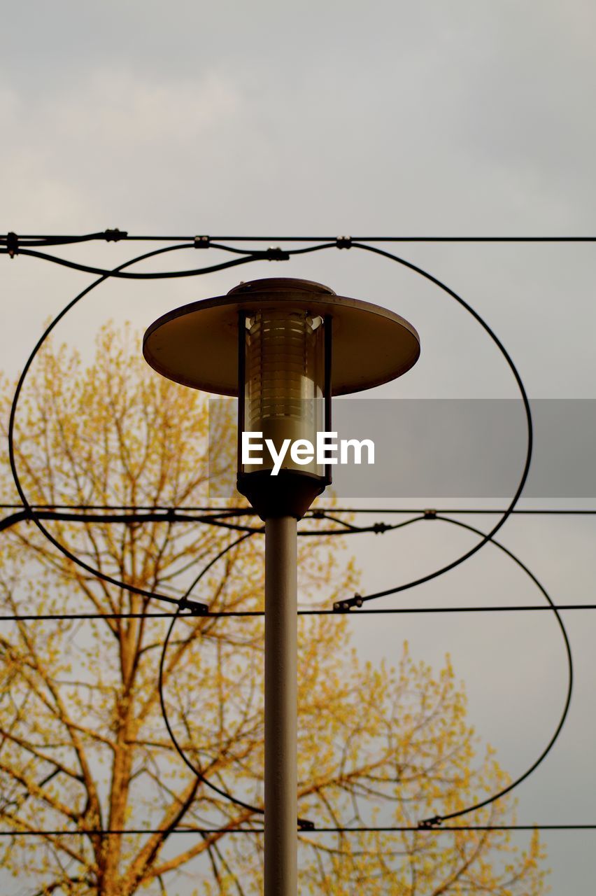 LOW ANGLE VIEW OF STREET LIGHT AGAINST ORANGE SKY