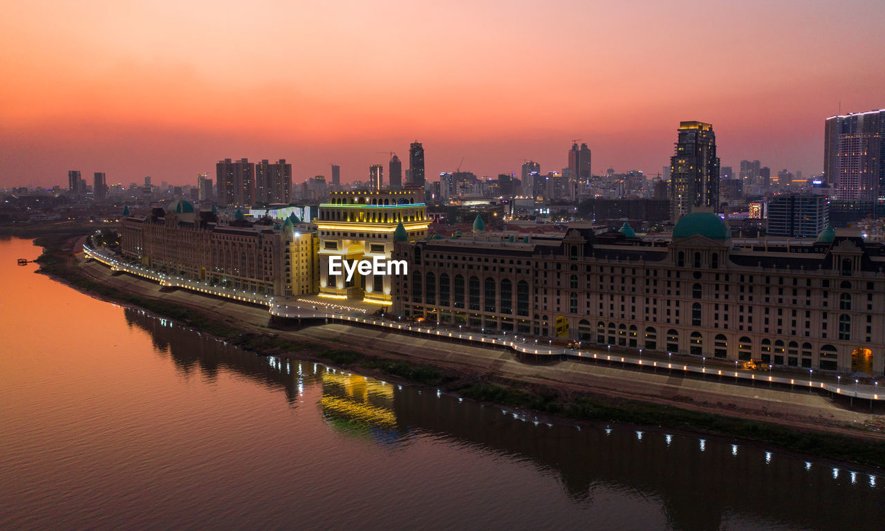 ILLUMINATED CITY BUILDINGS AT SUNSET