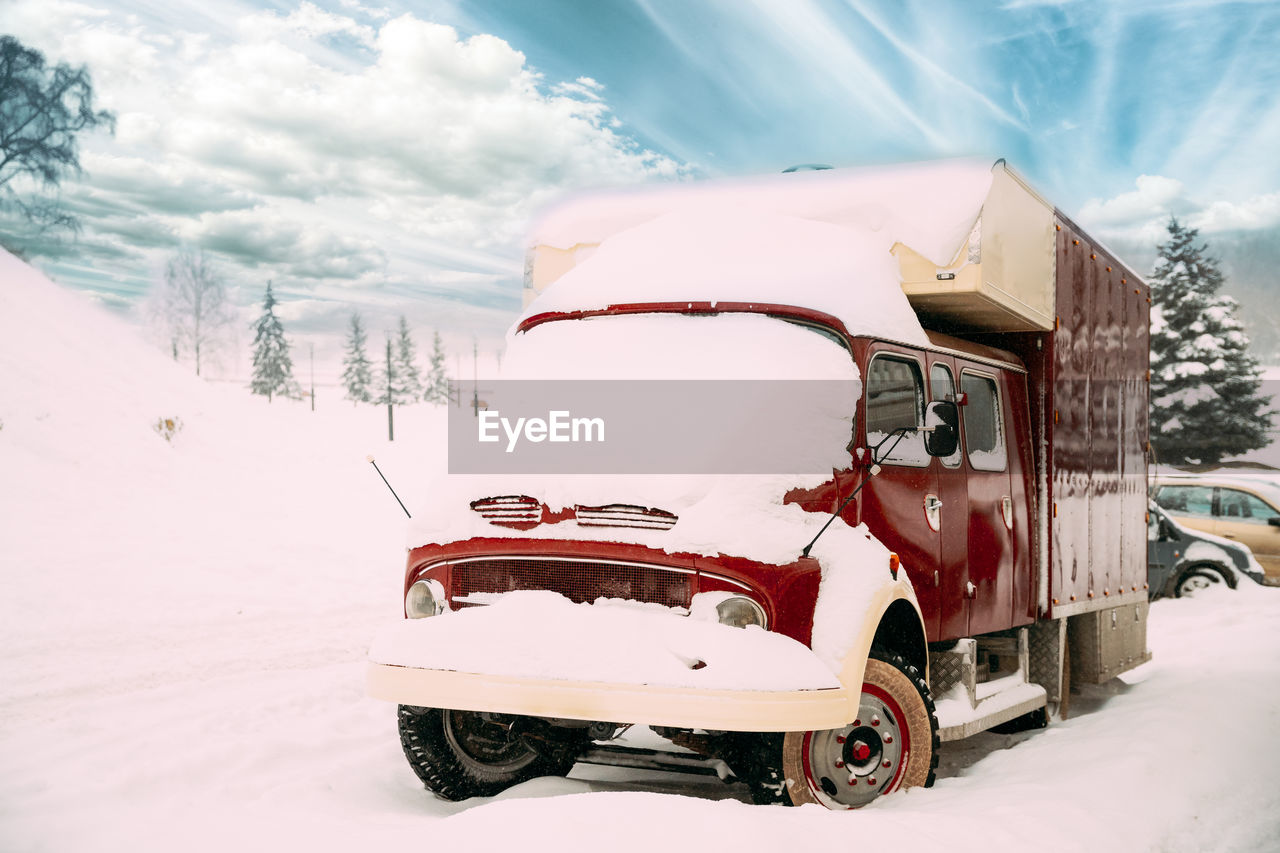 vintage car on snow covered field