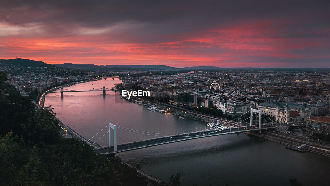 High angle view of suspension bridge over river during sunset