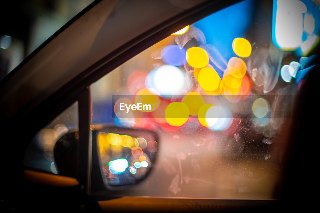 light, illuminated, mode of transportation, transportation, car, night, glass, window, motor vehicle, city, yellow, street, vehicle interior, indoors, travel, land vehicle, city life, architecture, lighting equipment, taxi, car interior, lighting, traffic, windshield, no people, lens flare, technology, reflection, close-up, city street, multi colored, light - natural phenomenon
