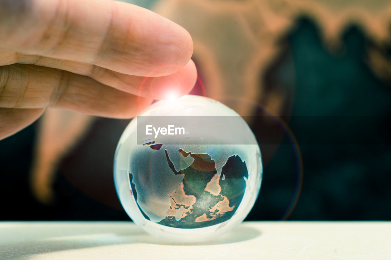 Close-up of man holding crystal ball