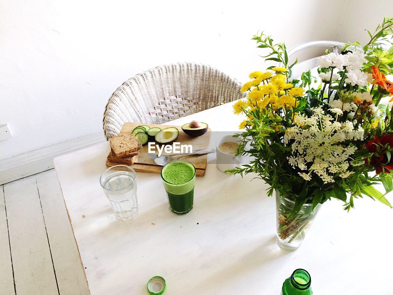 High angle view of breakfast and flower vase on table